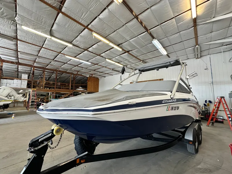 Slide: The Image of 2012 Yamaha Boats 212X in storage, covered and on trailer, inside a spacious warehouse. - 4