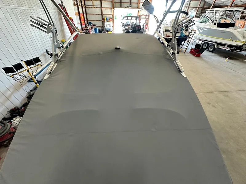 Slide: The Image of Covered 2012 Yamaha Boats 212X in a storage facility, showcasing protective tarp and equipment. - 5