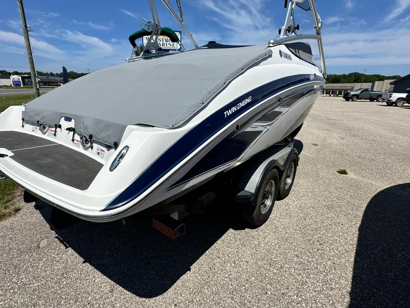 Slide: The Image of 2012 Yamaha Boats 212X on trailer, covered, twin engine, parked outdoors. - 6