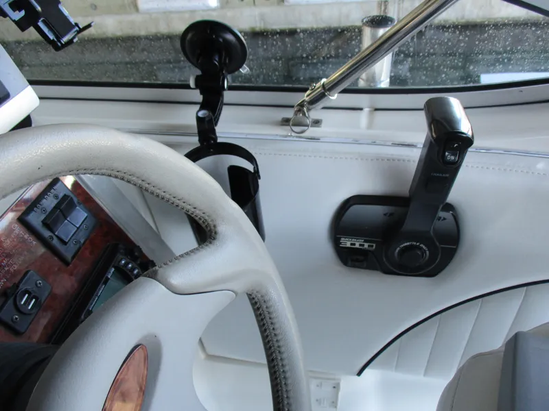 Slide: The Image of 1998 Bayliner 2855 Ciera Sunbridge helm with steering wheel and control panel. - 11