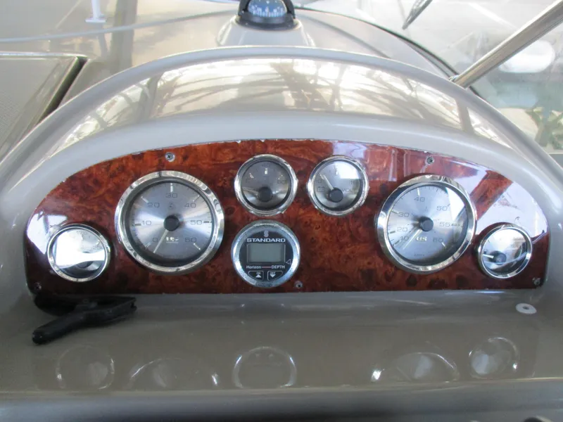Slide: The Image of 1998 Bayliner 2855 Ciera Sunbridge dashboard with wood panel and gauges. - 12