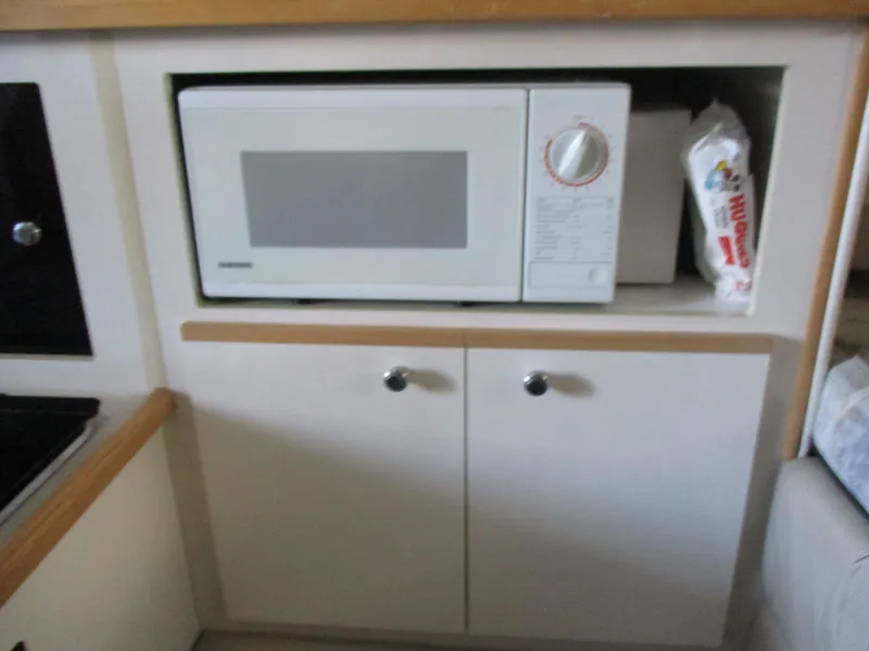 Slide: The Image of Microwave in 1998 Bayliner 2855 Ciera Sunbridge boat kitchen area. - 16