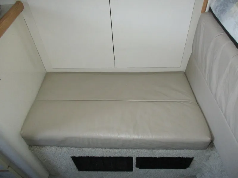 Slide: The Image of 1998 Bayliner 2855 Ciera Sunbridge interior with beige cushioned seating. - 17