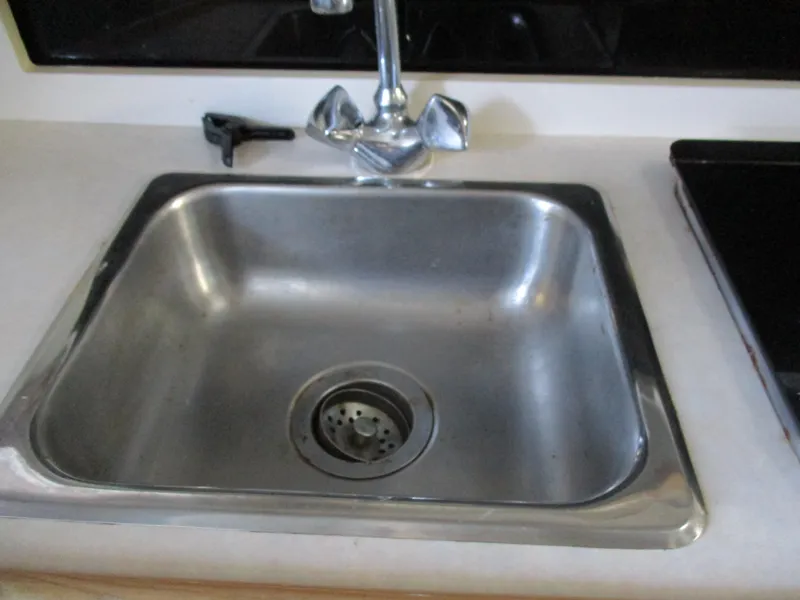 Slide: The Image of Stainless steel sink in 1998 Bayliner 2855 Ciera Sunbridge boat kitchen. - 23