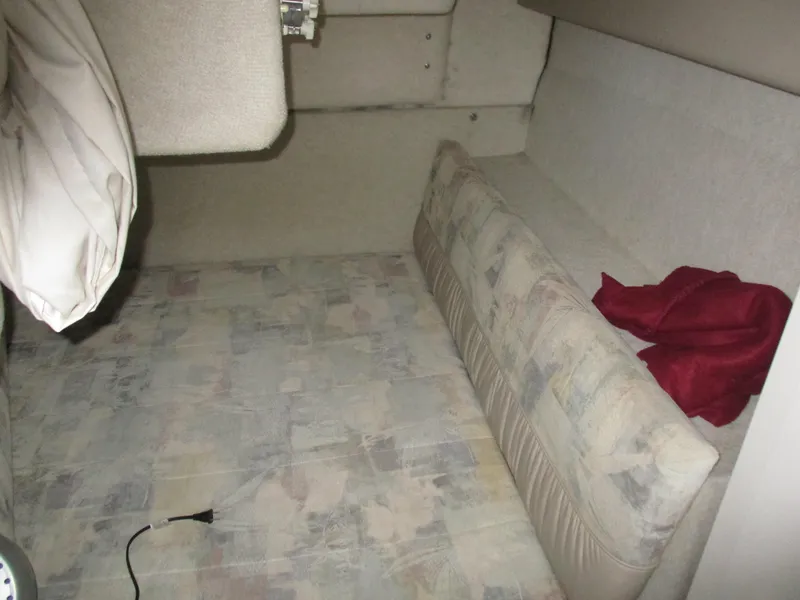 Slide: The Image of Interior cabin of 1998 Bayliner 2855 Ciera Sunbridge with patterned upholstery and red fabric. - 25