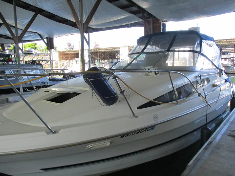 Slide: The Image of 1998 Bayliner 2855 Ciera Sunbridge boat docked in a covered marina. - 3
