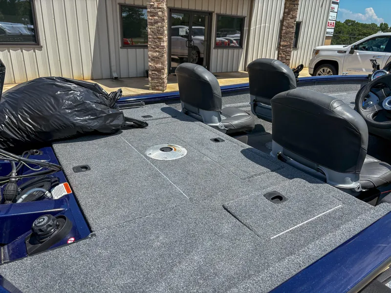 Slide: The Image of 2019 Tracker Pro Team 175 TF boat interior with gray carpet and seating. - 11