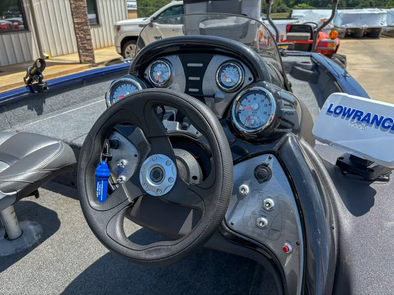 Slide: The Image of 2019 Tracker Pro Team 175 TF boat dashboard with steering wheel and gauges. - 12