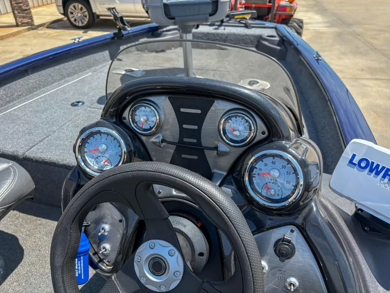 Slide: The Image of 2019 Tracker Pro Team 175 TF boat dashboard with gauges and steering wheel. - 13