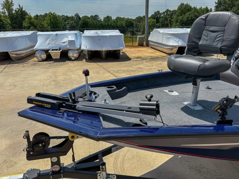 Slide: The Image of 2019 Tracker Pro Team 175 TF boat with Minn Kota trolling motor and seating, parked outdoors. - 5