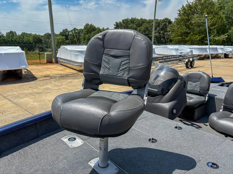 Slide: The Image of 2019 Tracker Pro Team 175 TF boat with gray seating and console, parked outdoors. - 6