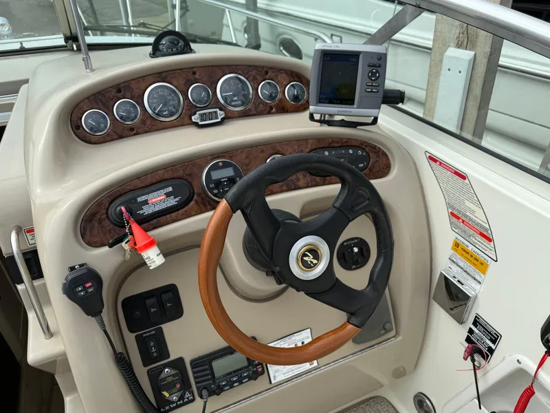Slide: The Image of Cockpit of 2002 Sea Ray 260 Sundancer with steering wheel and navigation instruments. - 13