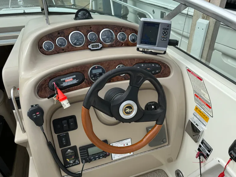 Slide: The Image of 2002 Sea Ray 260 Sundancer dashboard with steering wheel and navigation instruments. - 3
