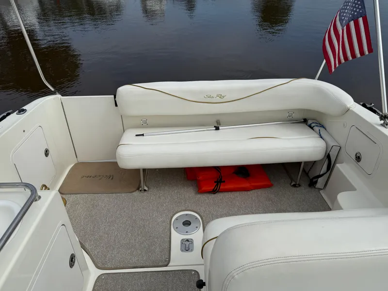 Slide: The Image of 2002 Sea Ray 260 Sundancer boat interior with seating and American flag. - 4