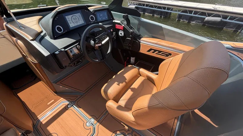 Slide: The Image of Interior of 2025 MB B52 25 Alpha boat with tan leather seating and modern dashboard. - 18
