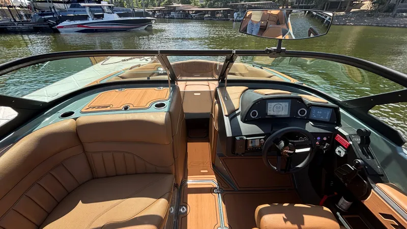 Slide: The Image of Interior view of 2025 MB B52 25 Alpha boat with luxurious seating and modern dashboard. - 22