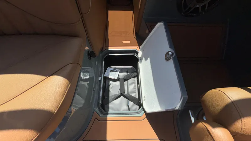 Slide: The Image of 2025 MB B52 25 Alpha interior with open storage compartment and brown leather seats. - 33