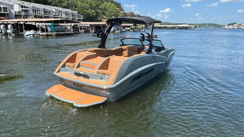 Slide: The Image of 2025 MB B52 25 Alpha boat on a lake, featuring sleek design and luxury seating. - 4