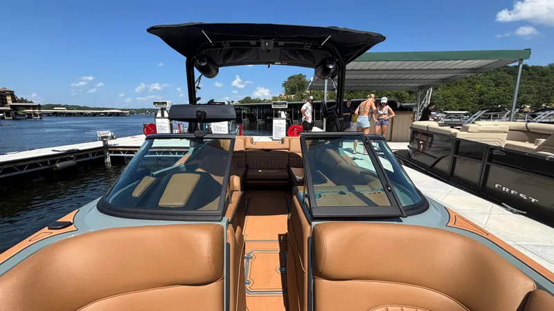 Slide: The Image of 2025 MB B52 25 Alpha boat docked, featuring tan interior and sleek design. - 40