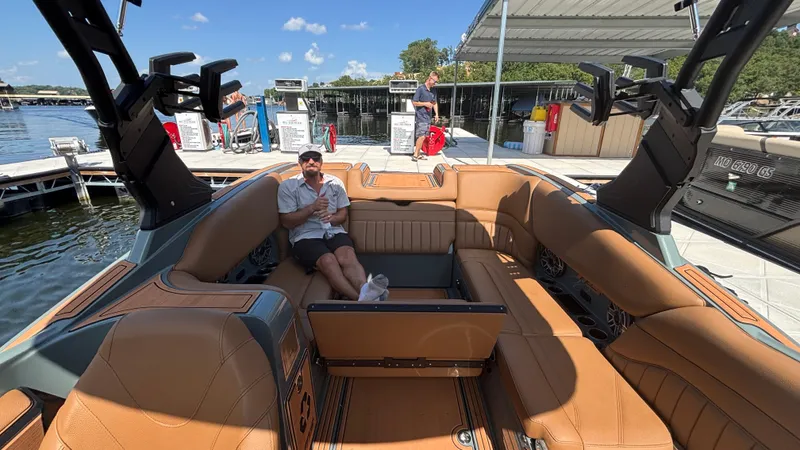 Slide: The Image of Man relaxing on luxurious 2025 MB B52 25 Alpha boat at marina. - 42