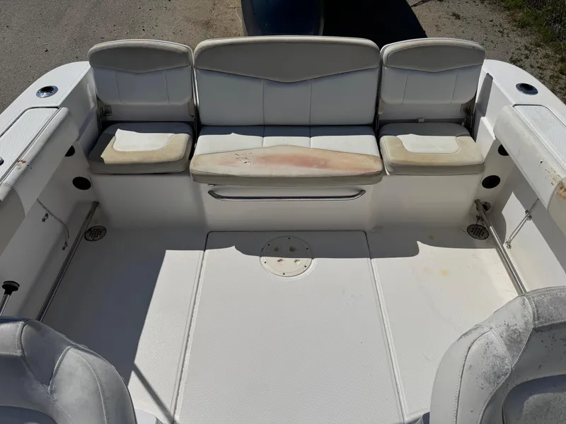 Slide: The Image of 2014 Robalo R207 Dual Console boat interior with white seating and storage compartments. - 11