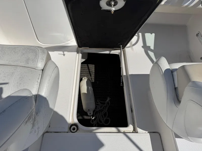 Slide: The Image of 2014 Robalo R207 Dual Console boat interior with open storage compartment. - 14