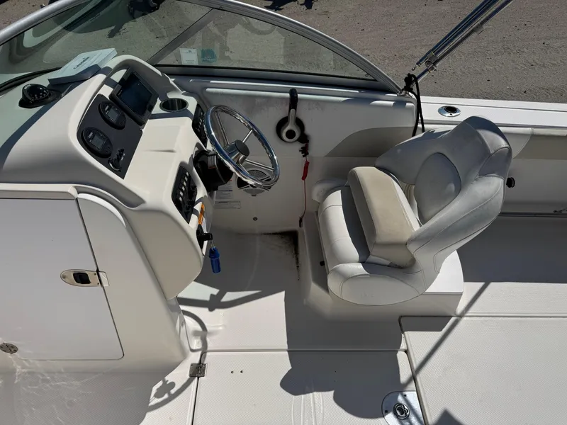 Slide: The Image of 2014 Robalo R207 Dual Console boat interior with steering wheel and seating. - 15