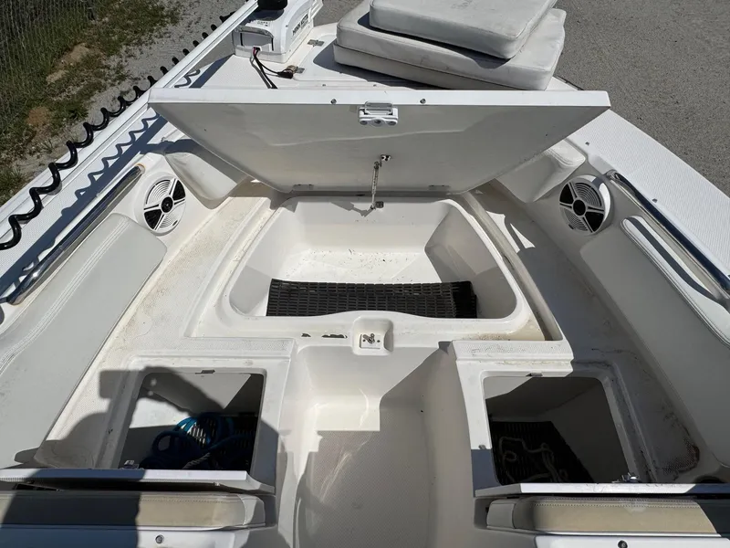 Slide: The Image of 2014 Robalo R207 Dual Console boat storage compartments and seating area. - 17