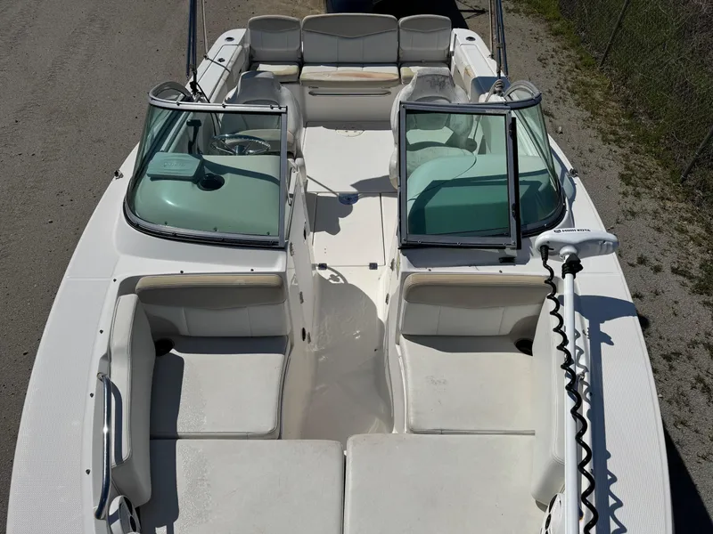 Slide: The Image of 2014 Robalo R207 Dual Console boat interior with seating and windshield, viewed from above. - 19