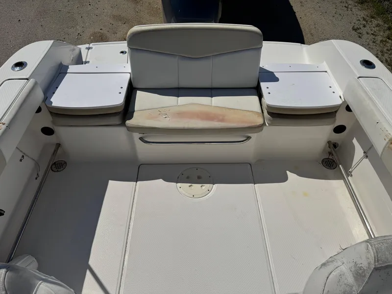 Slide: The Image of 2014 Robalo R207 Dual Console boat interior with white seating and storage compartments. - 9