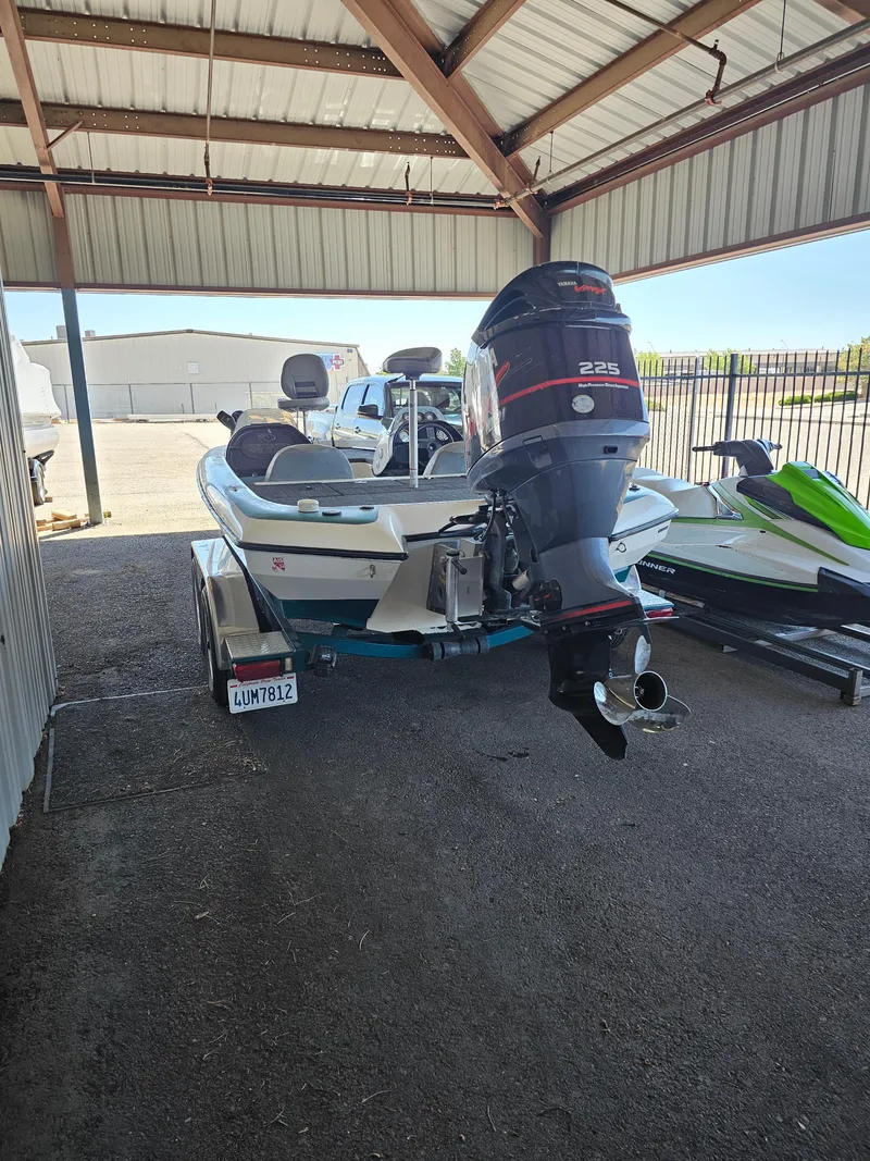 Slide: The Image of 2005 Blazer 202 Pro-V boat with outboard motor under a metal canopy. - 3