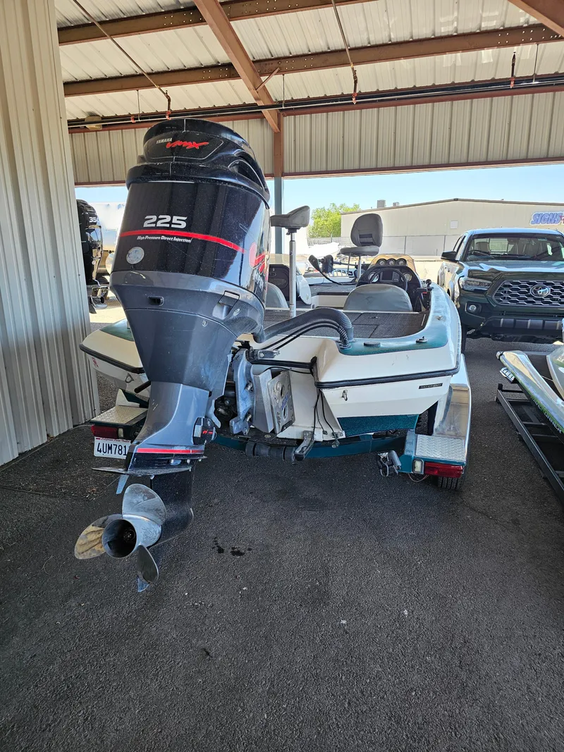 Slide: The Image of 2005 Blazer 202 Pro-V boat with 225 horsepower engine, parked under a metal roof. - 5