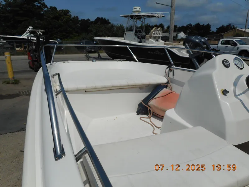 Slide: The Image of 2010 Boston Whaler 150 Super Sport boat interior with seating and console. - 4