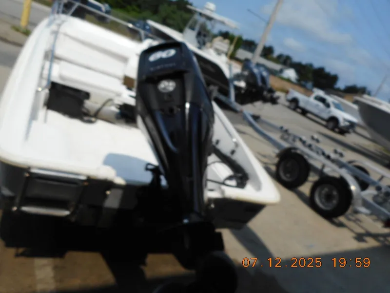 Slide: The Image of 2010 Boston Whaler 150 Super Sport boat with outboard motor on trailer. - 6