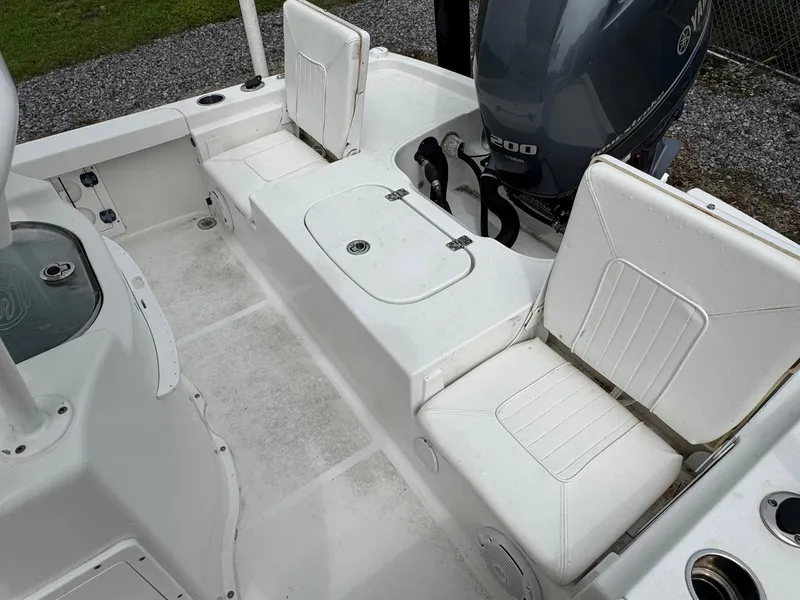 Slide: The Image of 2016 Sea Hunt BX22 boat interior with white seating and Yamaha 200 engine. - 10