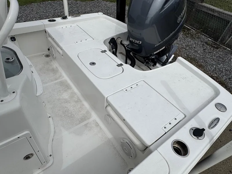 Slide: The Image of 2016 Sea Hunt BX22 boat deck with Yamaha 200 engine, featuring storage compartments. - 11