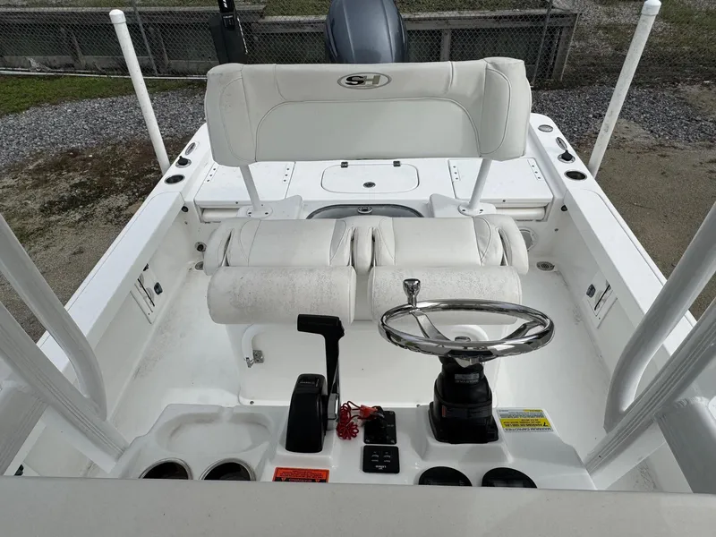 Slide: The Image of 2016 Sea Hunt BX22 boat cockpit with steering wheel and seating. - 18