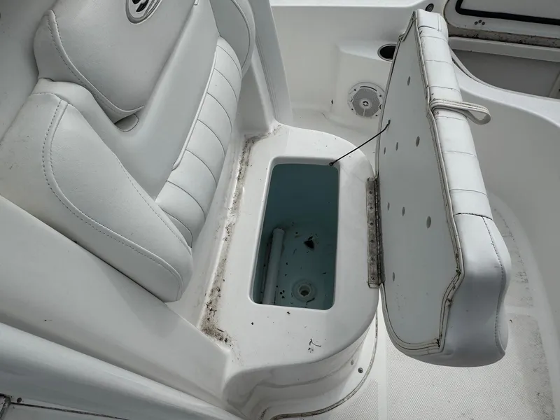 Slide: The Image of 2016 Sea Hunt BX22 boat seat with open storage compartment. - 19