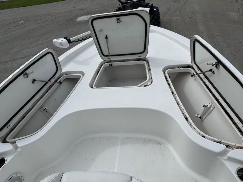 Slide: The Image of 2016 Sea Hunt BX22 boat with open storage compartments on deck. - 21