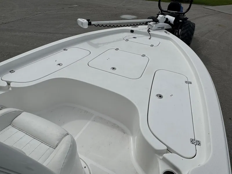 Slide: The Image of 2016 Sea Hunt BX22 boat deck with storage compartments and seating. - 22