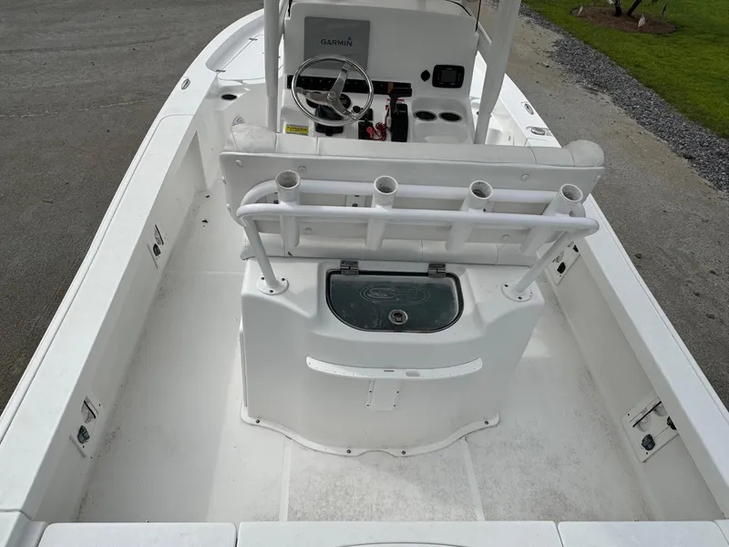 Slide: The Image of 2016 Sea Hunt BX22 boat interior with steering console and rod holders. - 23