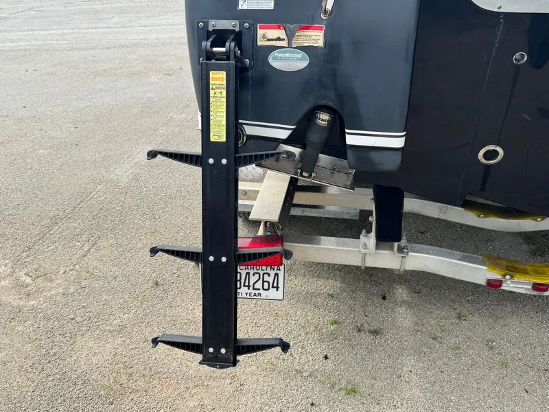 Slide: The Image of 2016 Sea Hunt BX22 boat with trailer and license plate, featuring a mounted accessory. - 24