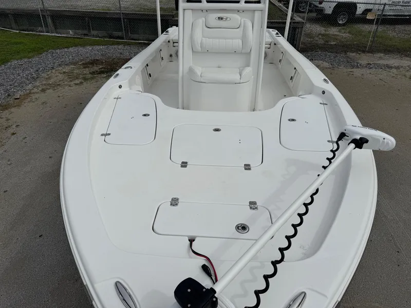 Slide: The Image of 2016 Sea Hunt BX22 boat deck with seating and storage compartments. - 26