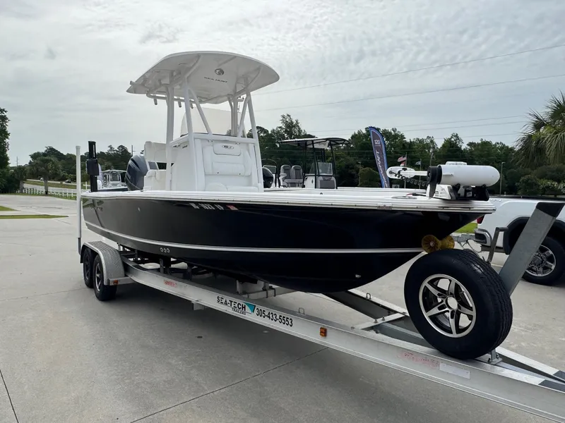 Slide: The Image of 2016 Sea Hunt BX22 boat on trailer, parked outdoors, showcasing sleek design and modern features. - 5
