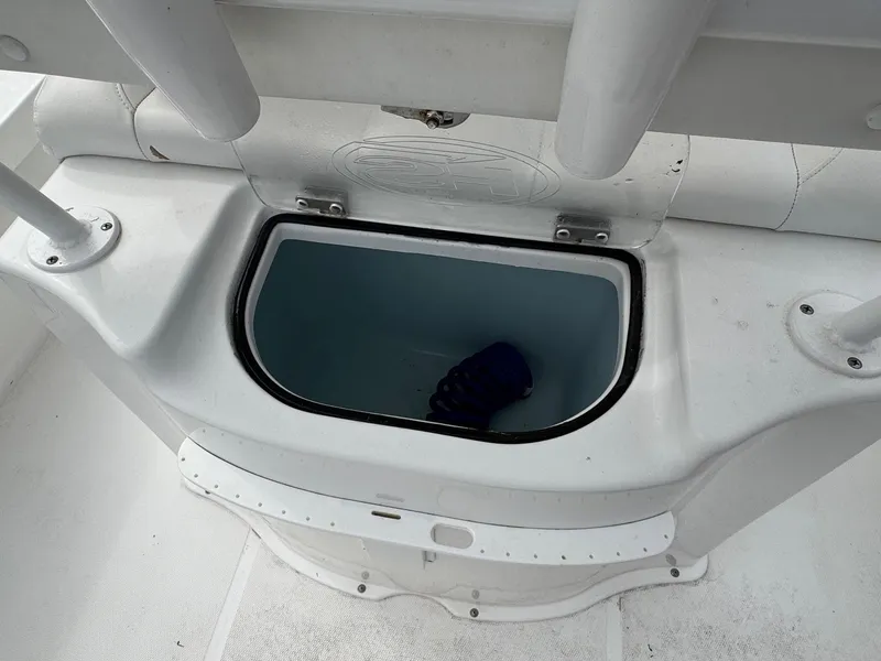 Slide: The Image of 2016 Sea Hunt BX22 boat storage compartment with open lid and blue item inside. - 8