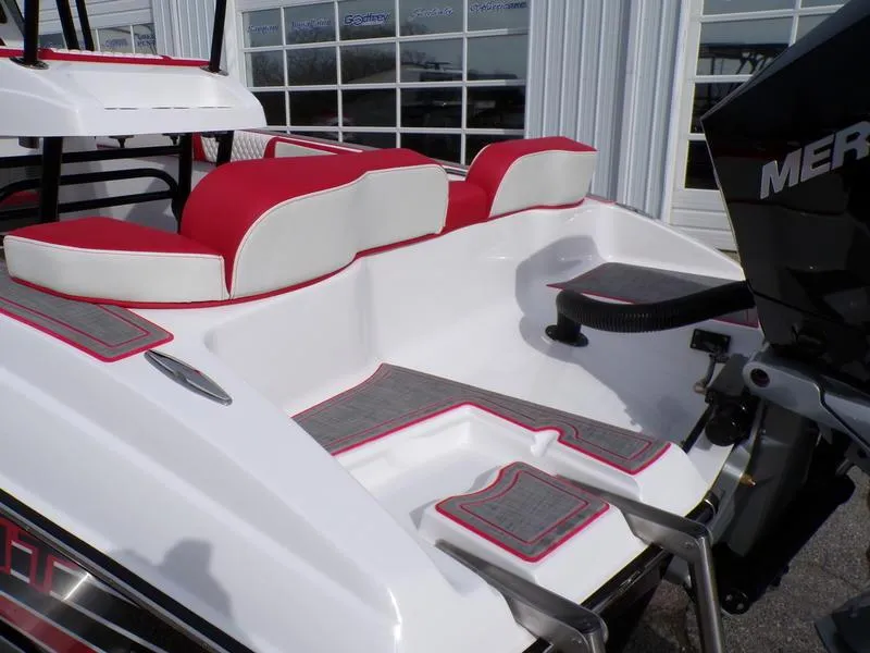 Slide: The Image of 2026 Statement 250 Center Console boat with red and white seating, rear view. - 14