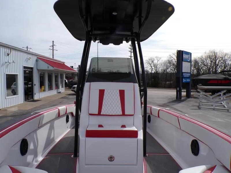 Slide: The Image of 2026 Statement 250 Center Console boat with red and white seating, docked at a marina. - 20