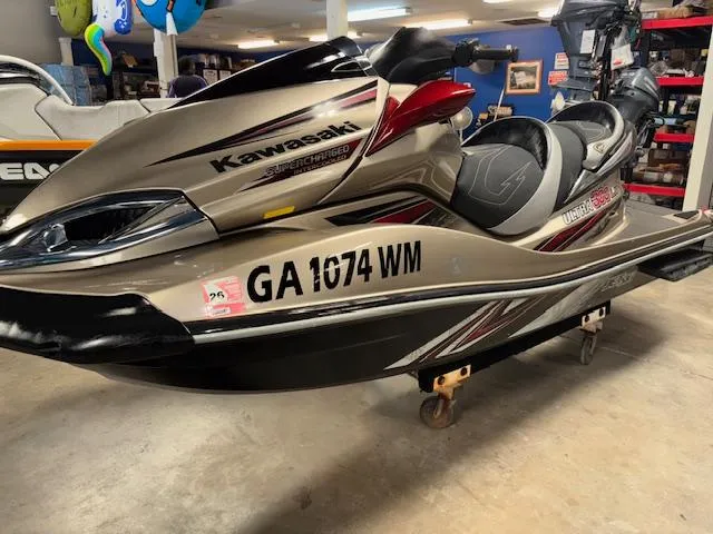 Slide: The Image of 2013 Kawasaki Ultra 300 LX jet ski in showroom, beige with red accents. - 3