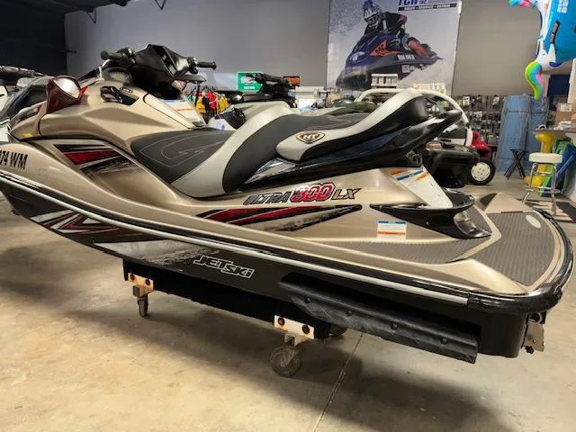Slide: The Image of 2013 Kawasaki Ultra 300 LX jet ski in showroom, side view. - 4