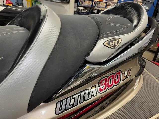 Slide: The Image of 2013 Kawasaki Ultra 300 LX jet ski seat and logo detail in a showroom. - 7